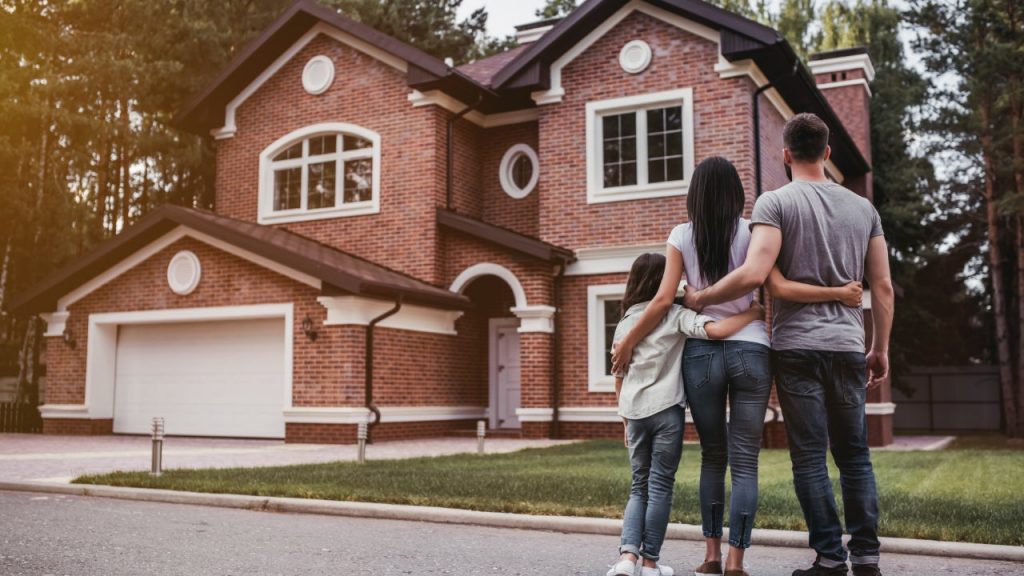 A person standing in front of a house
