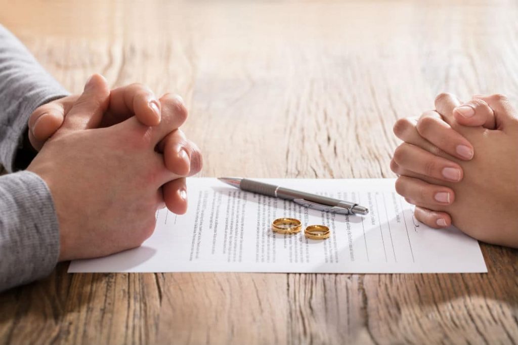 Fix An Appointment With Top Divorce Advocate people sitting at table rings and pen, paper on table